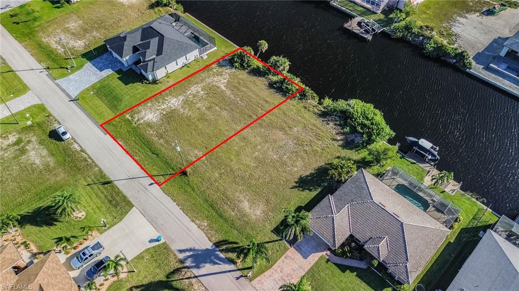 View from above of property with property parcel outlined and a nearby body of water