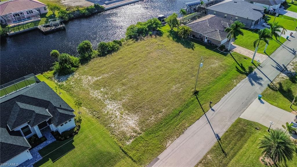 Aerial view of residential area featuring a nearby body of water