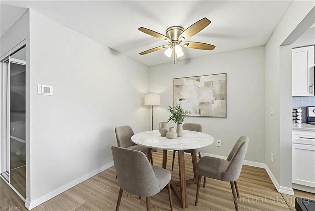 Dining space with light wood-type flooring and ceiling fan