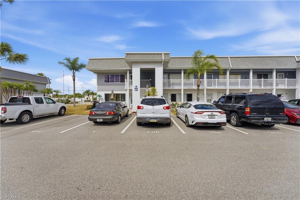 View of property featuring uncovered parking