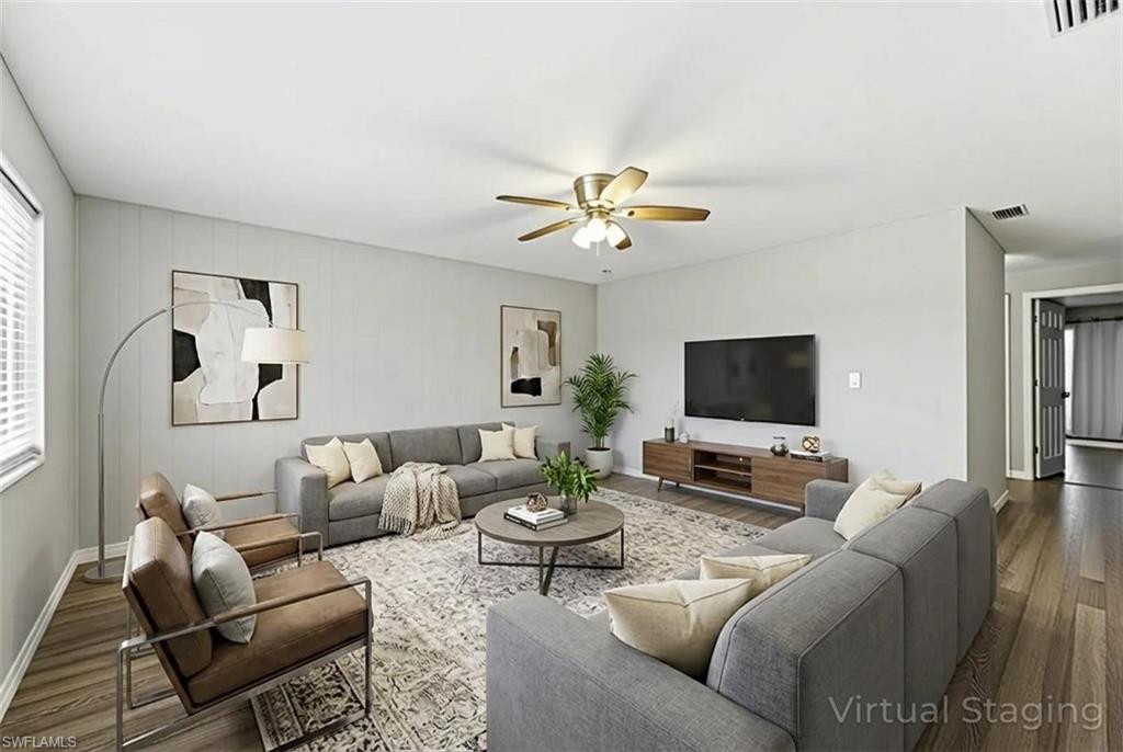 Living room featuring wood finished floors and ceiling fan