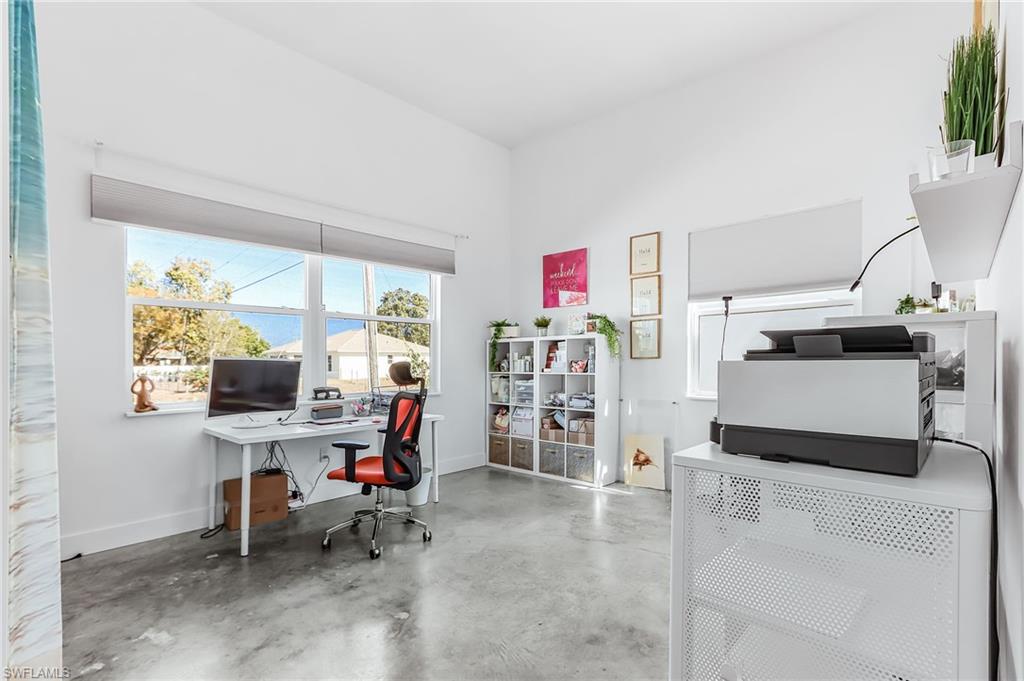 Office space with baseboards and finished concrete floors