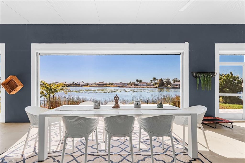 Dining area with concrete flooring and a water view