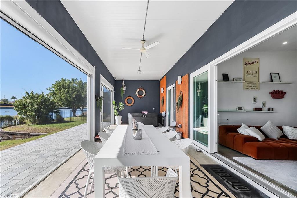 View of patio / terrace with a ceiling fan, outdoor dining area, and a water view