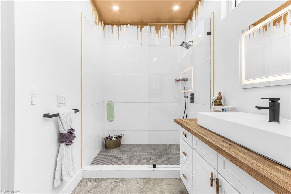 Full bath with a walk in shower, vanity, and recessed lighting