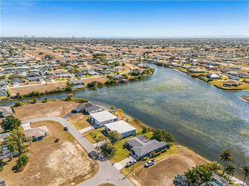 Aerial view of property's location with nearby suburban area and a large body of water
