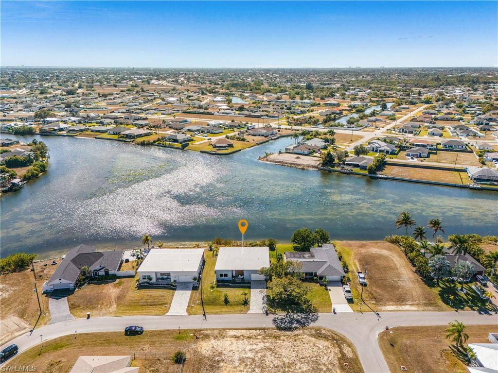 Aerial view of property's location with nearby suburban area