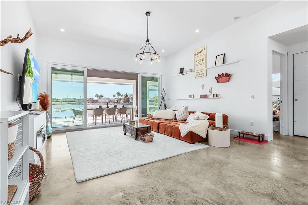 Living area featuring concrete floors and a chandelier