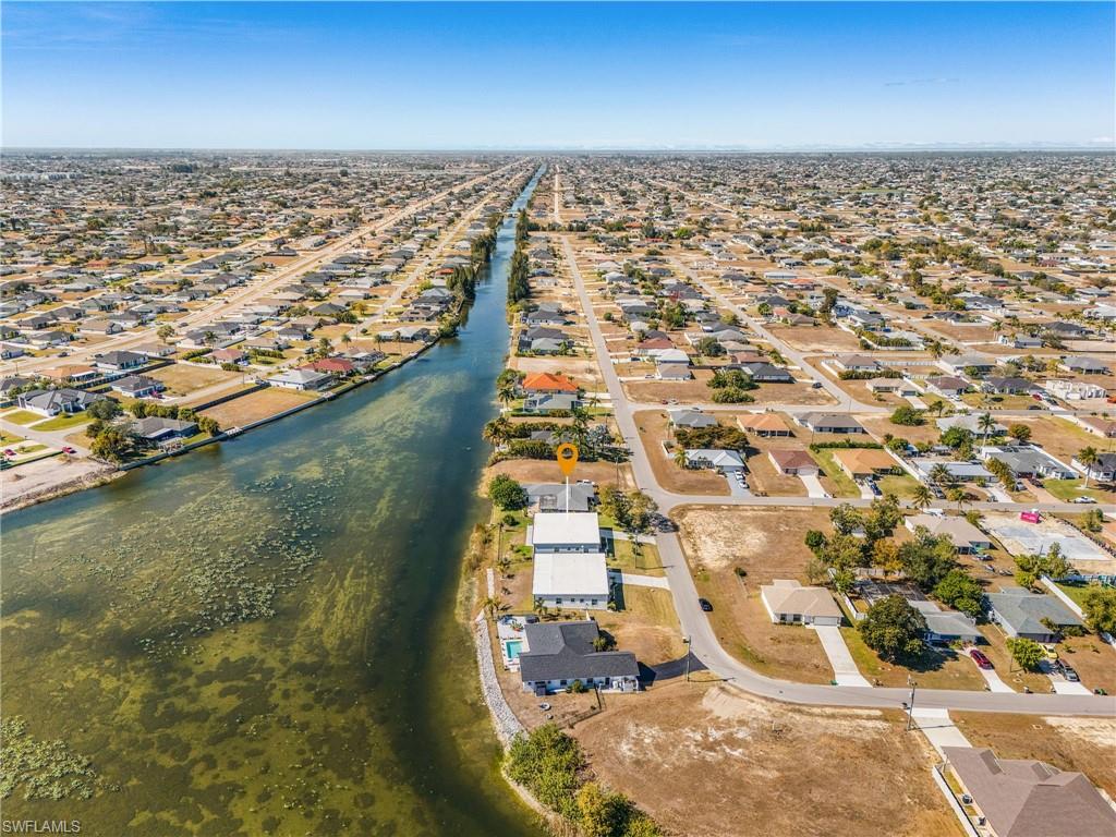 Aerial overview of property's location featuring nearby suburban area and a large body of water