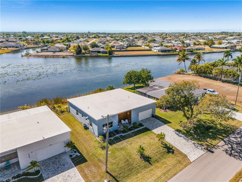Aerial perspective of suburban area featuring a large body of water