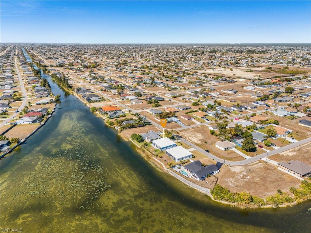 Aerial overview of property's location with nearby suburban area and a large body of water