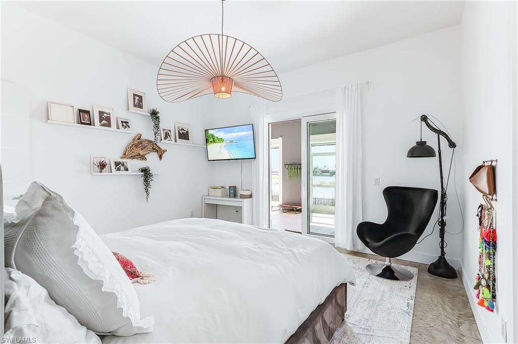 Bedroom with access to exterior and wood finished floors