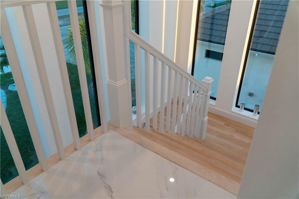 Staircase featuring wood finished floors
