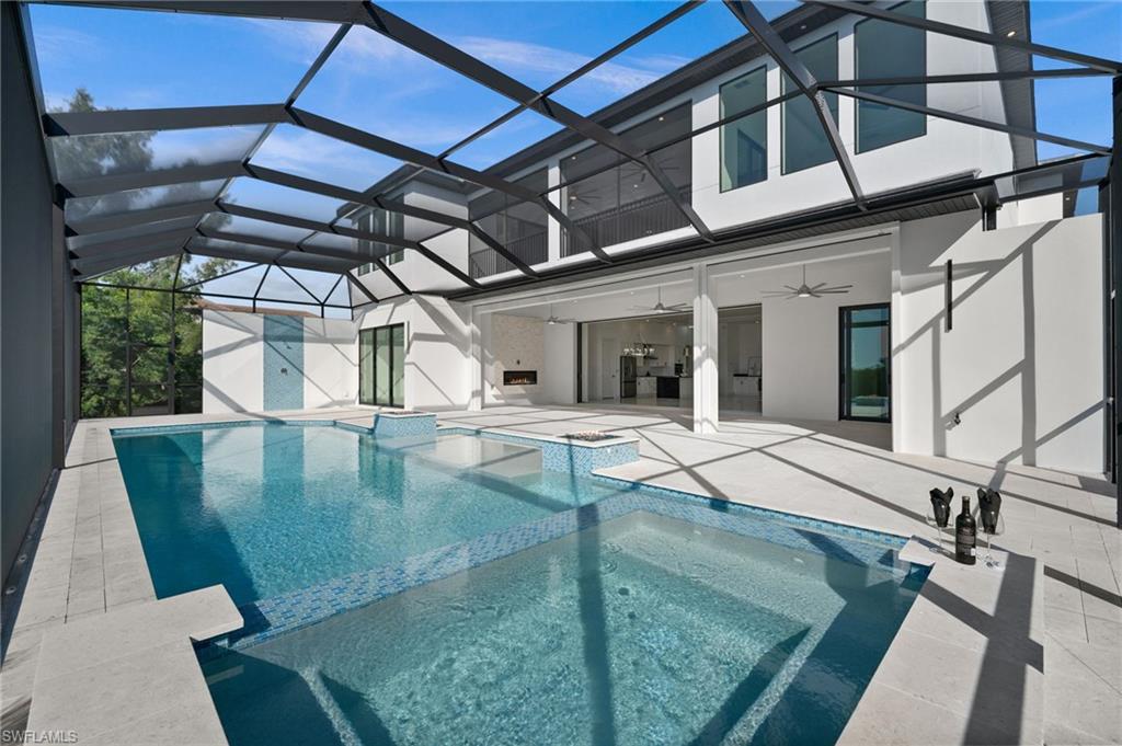 Integrated pool / spa featuring a sunroom, a patio area, and a lanai