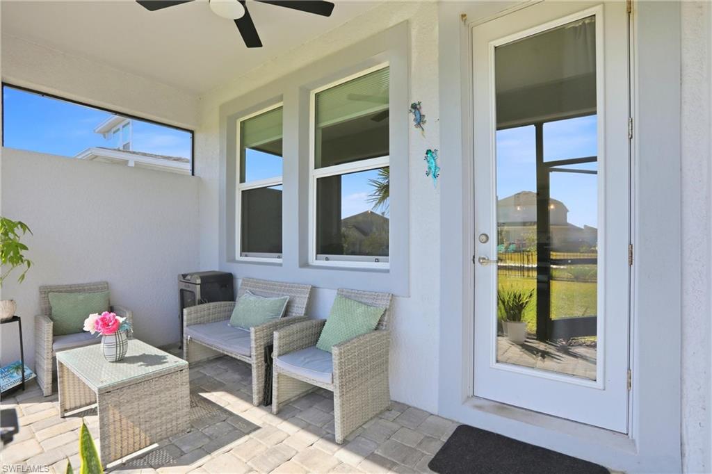 View of patio with a ceiling fan and an outdoor hangout area