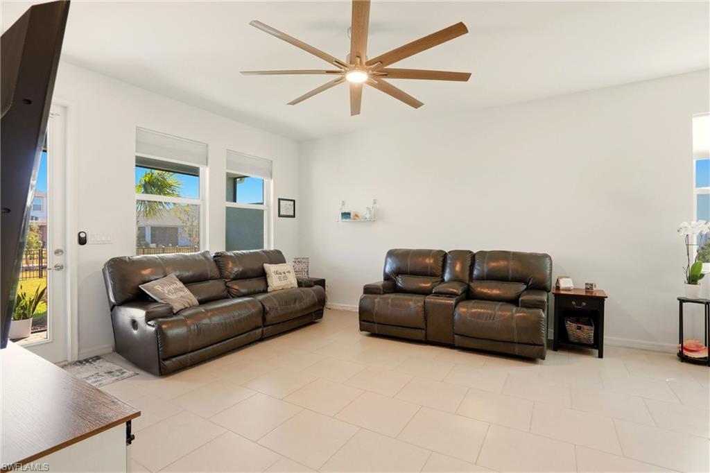Living room with baseboards and ceiling fan