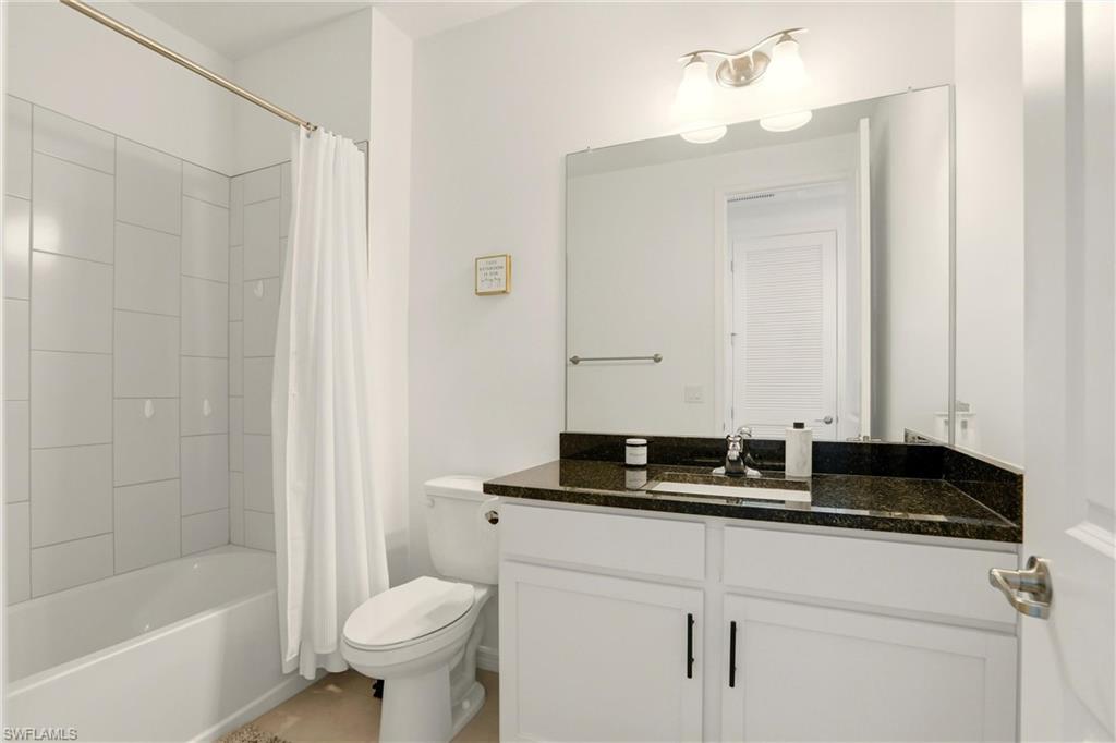 Bathroom featuring shower / tub combo and vanity