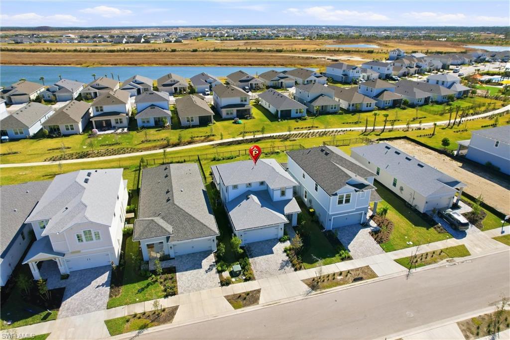 Aerial view of residential area featuring a large body of water