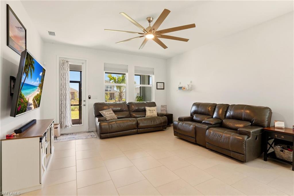 Living room featuring a ceiling fan and light tile patterned flooring