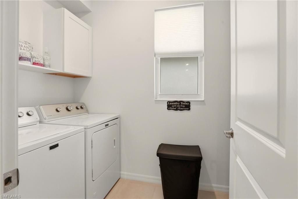 Laundry room with independent washer and dryer and cabinet space