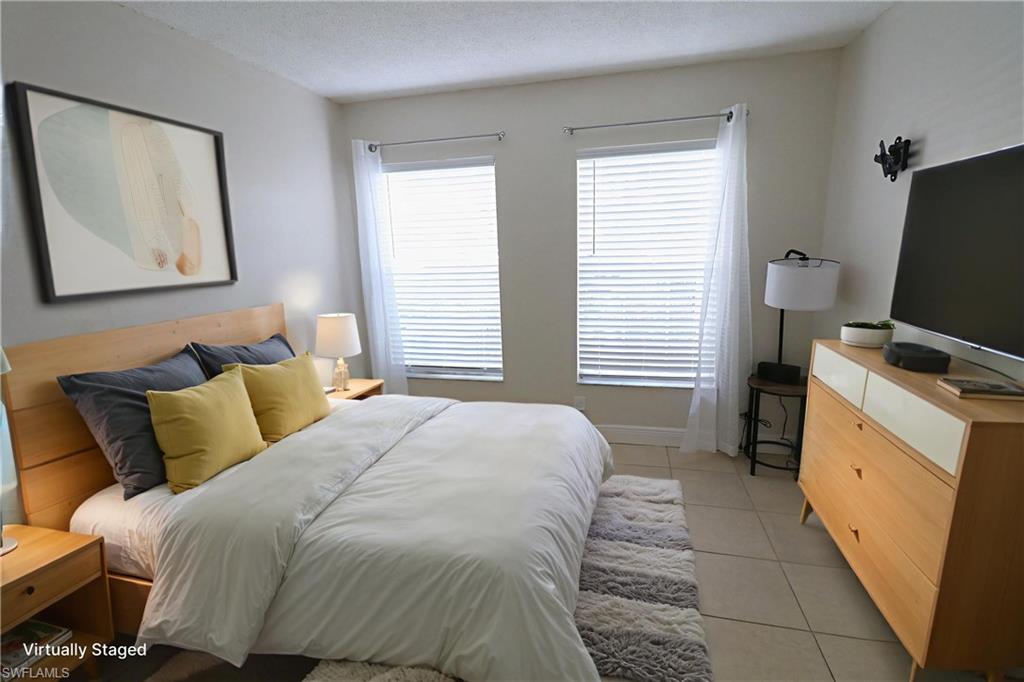 Bedroom featuring light tile patterned floors and a textured ceiling