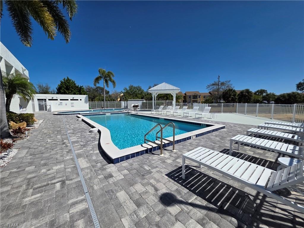 Community pool featuring a gazebo and a patio