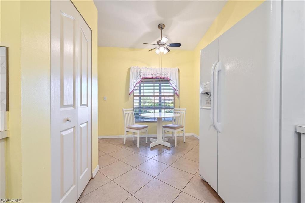 Dining area featuring light tile patterned flooring and a ceiling fan