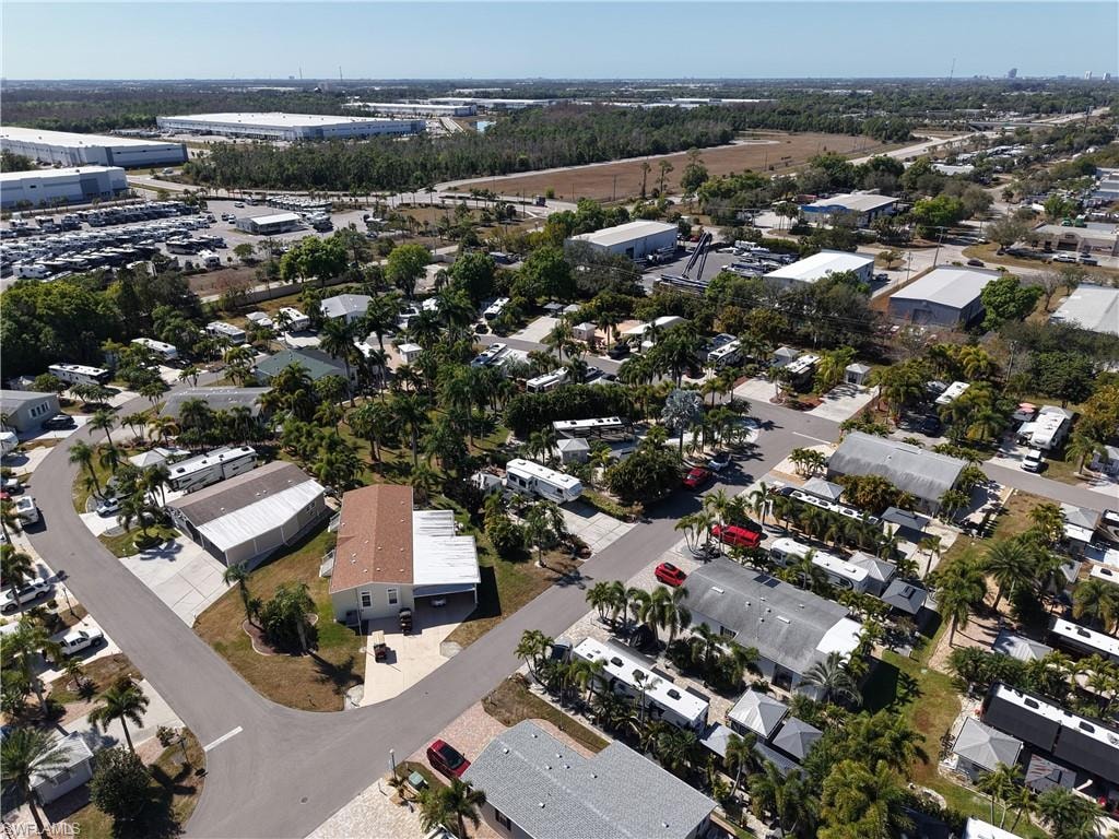 Aerial view of property and surrounding area featuring nearby suburban area