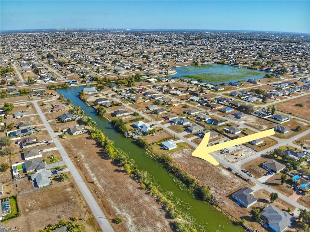 Aerial view of property's location featuring nearby suburban area and a nearby body of water