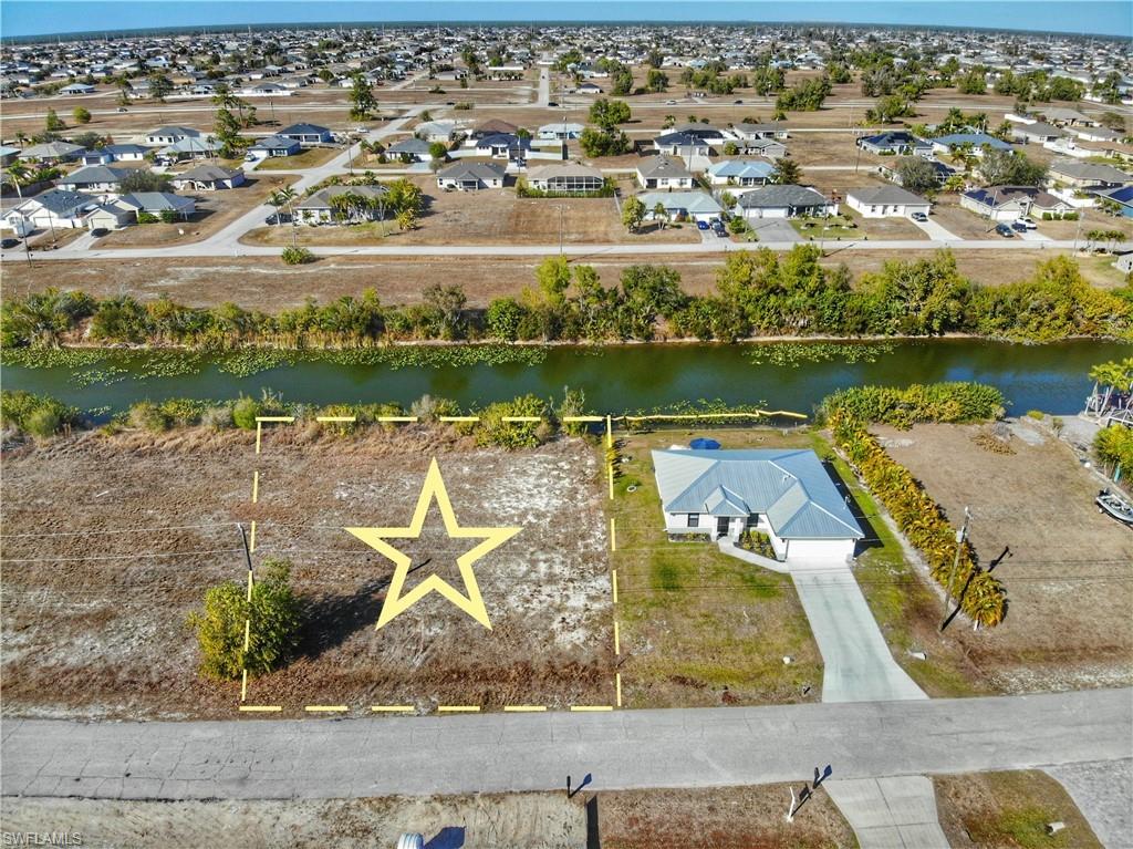 Aerial perspective of suburban area featuring a nearby body of water