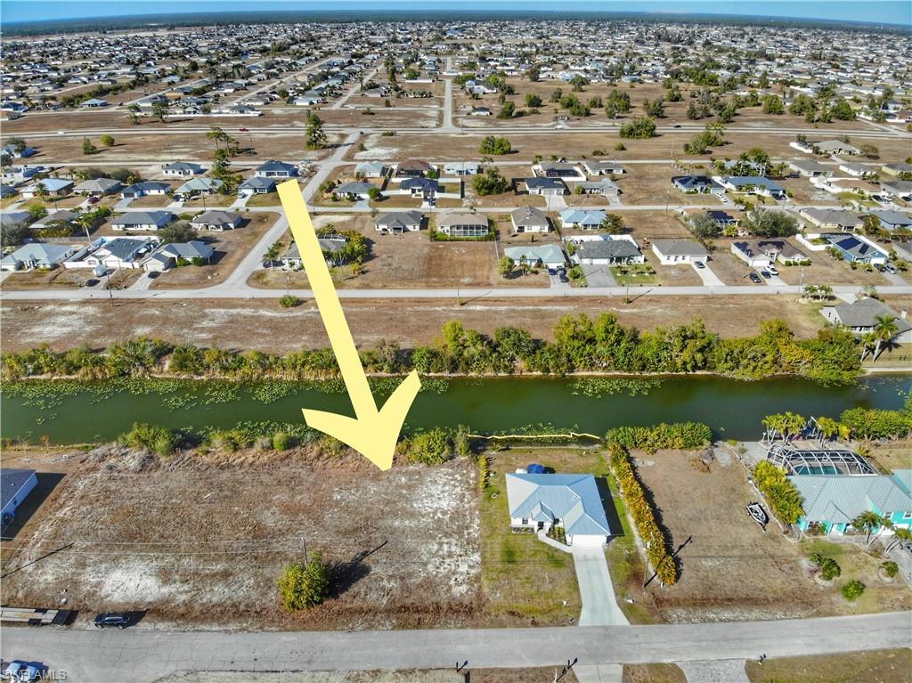 Aerial overview of property's location with nearby suburban area and a large body of water