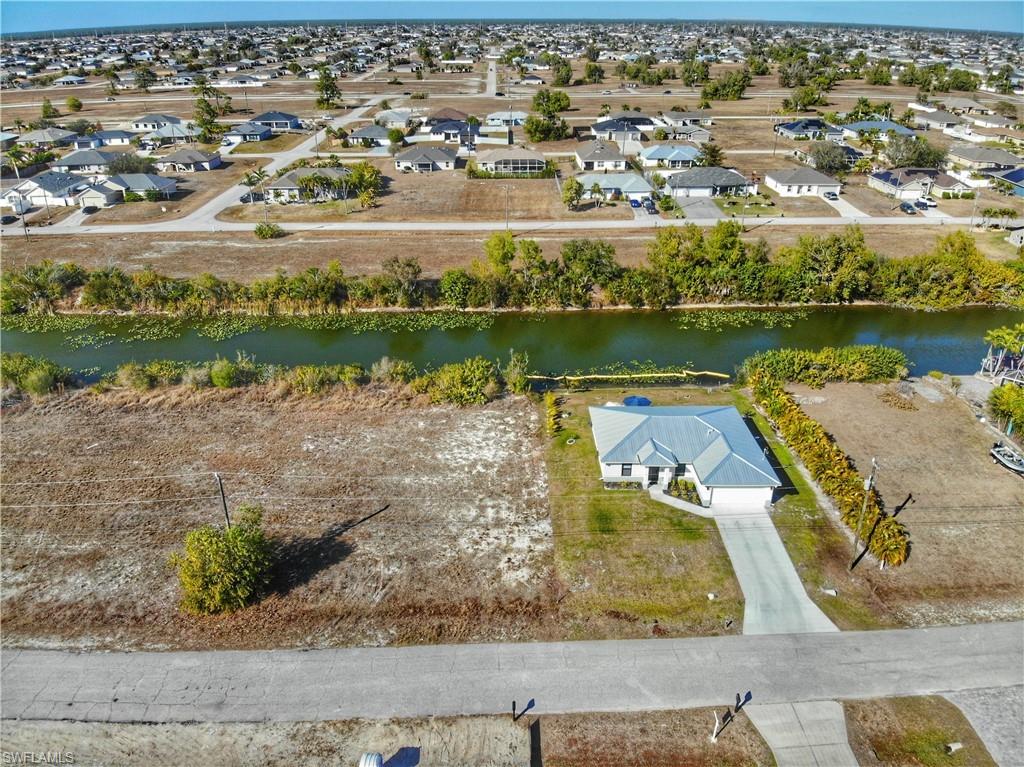 Aerial perspective of suburban area featuring a large body of water