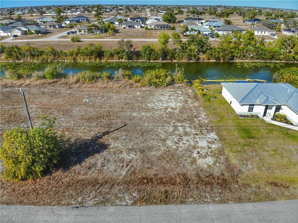 Aerial view of residential area featuring a large body of water