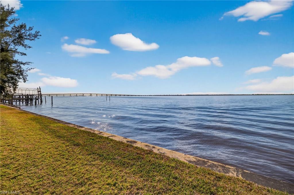 Dock area featuring a yard and a water view