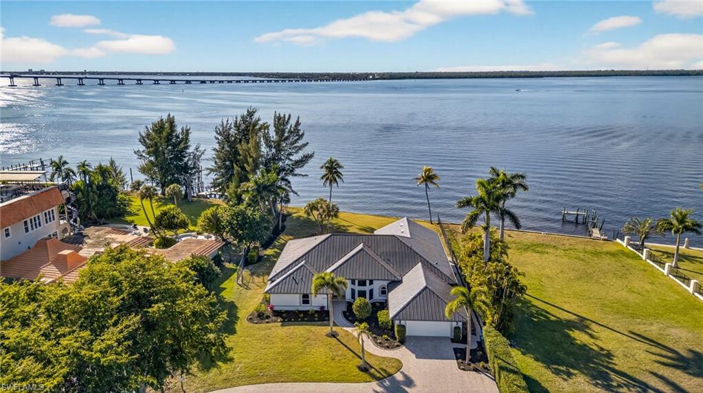 Aerial view of property and surrounding area featuring a nearby body of water