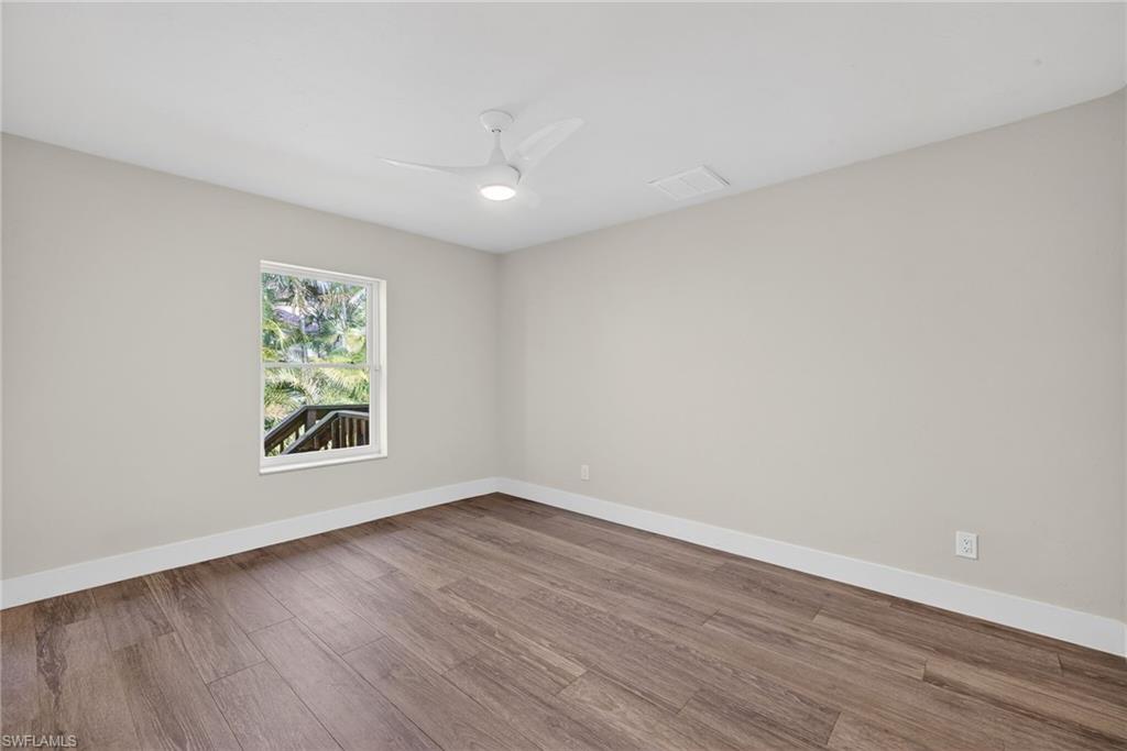 Spare room with wood finished floors and ceiling fan