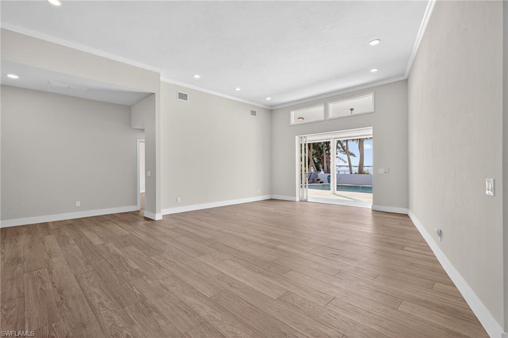 Spare room featuring light wood-style floors, recessed lighting, and crown molding