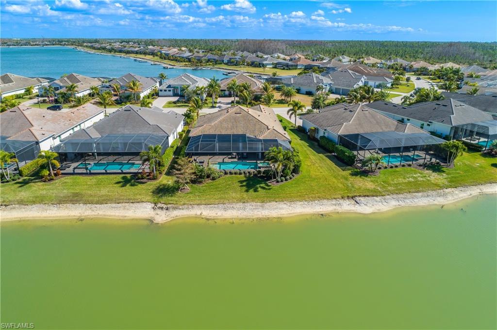 Aerial perspective of suburban area featuring a nearby body of water