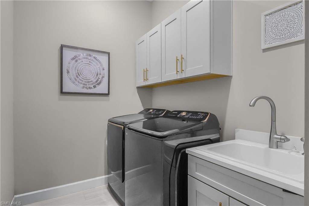 Laundry area with washing machine and dryer and cabinet space