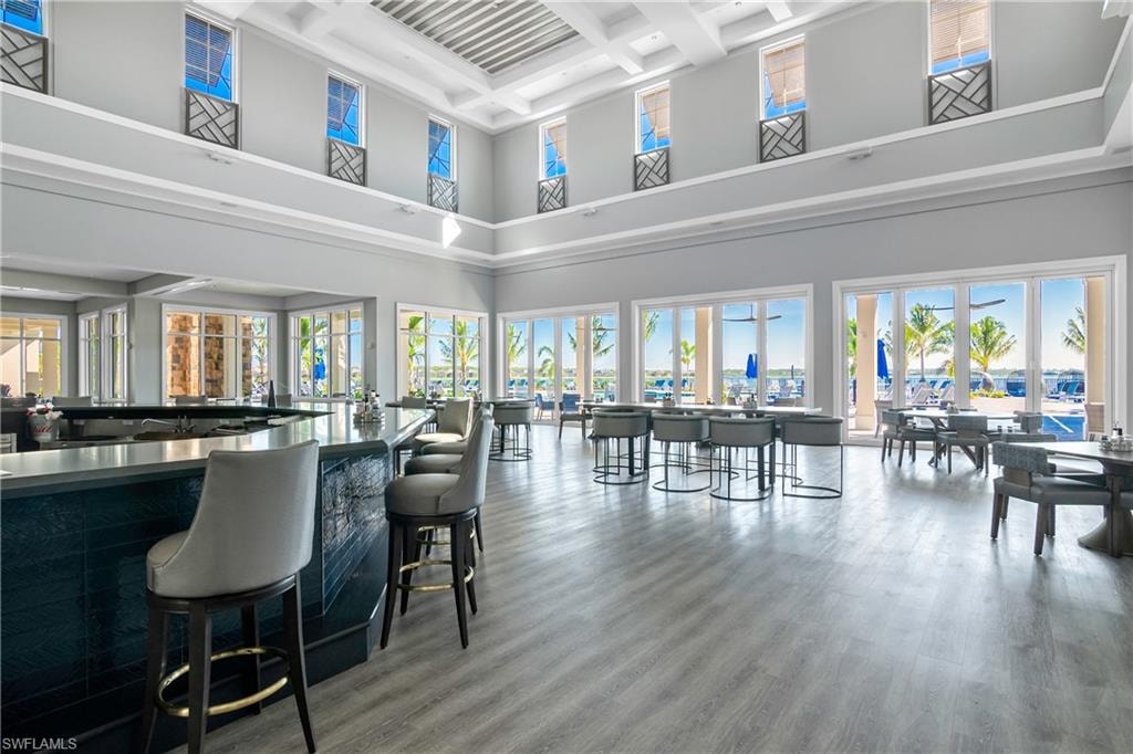 Bar area with coffered ceiling and dark countertops