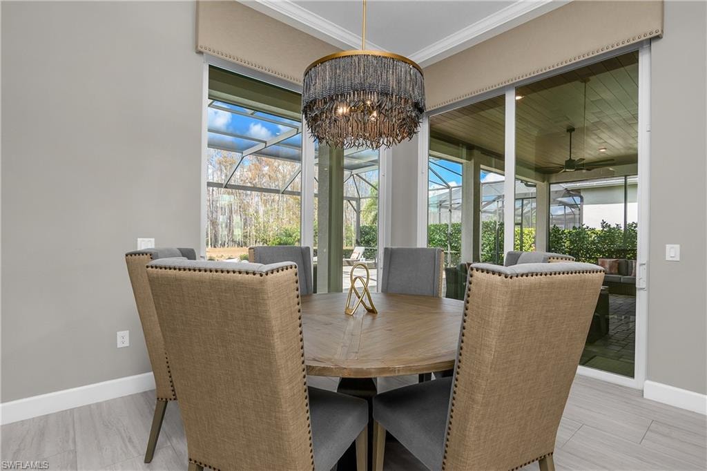 Dining area with a sunroom and ceiling fan