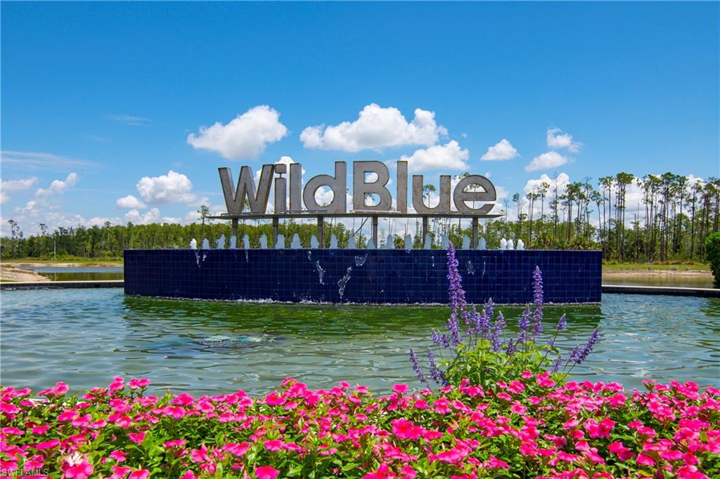 Community / neighborhood sign with a water view
