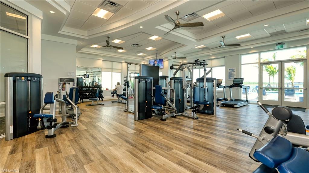 Workout area with ceiling fan, french doors, and a high ceiling