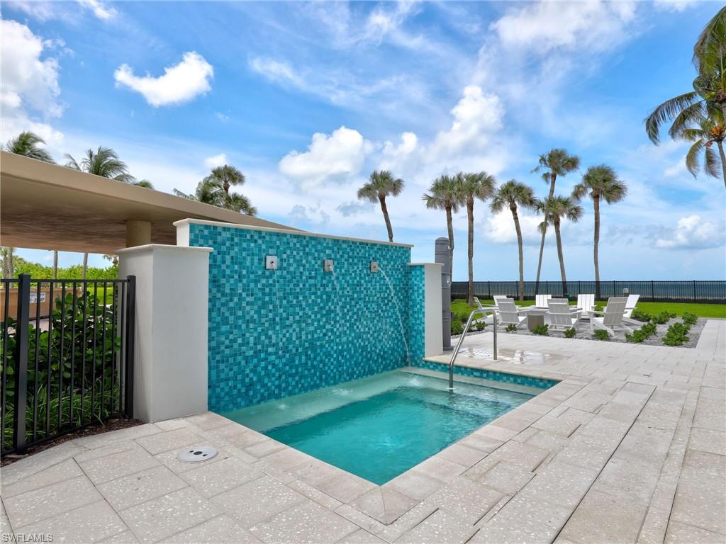 View of pool featuring a patio and a hot tub