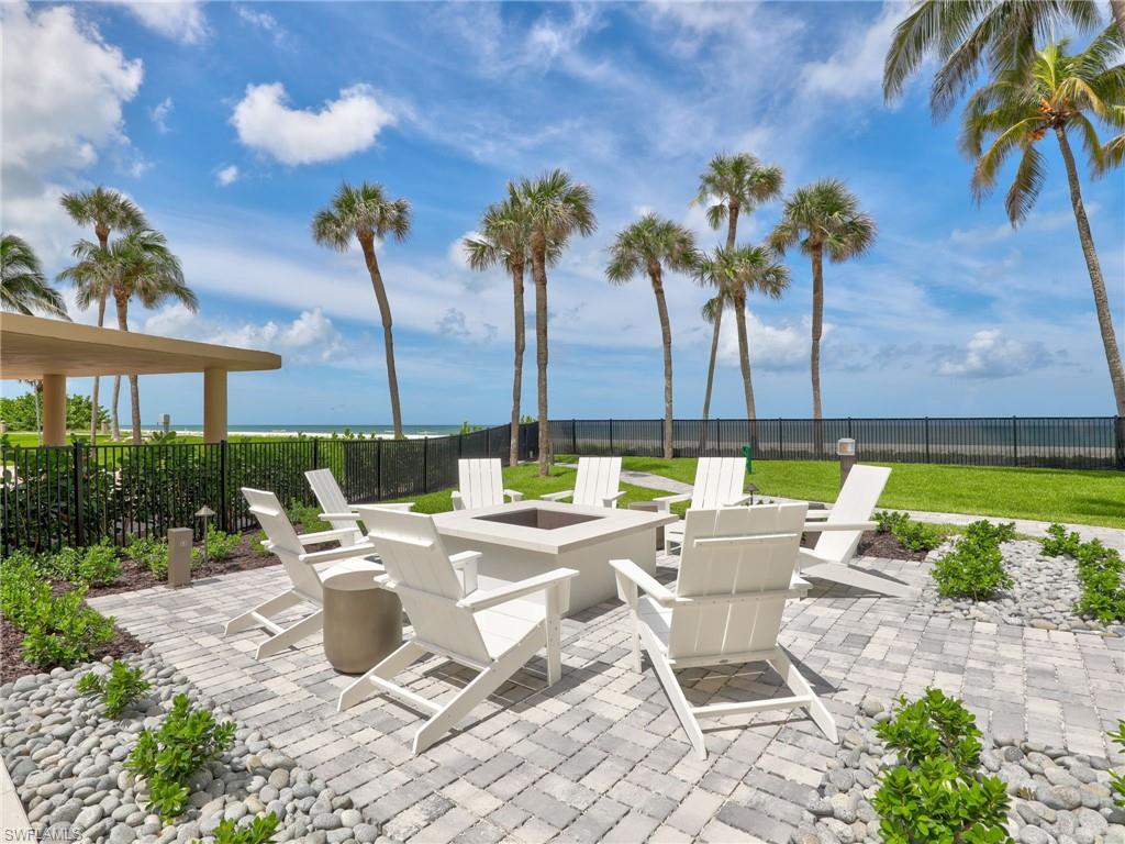 View of patio / terrace with an outdoor fire pit and a water view