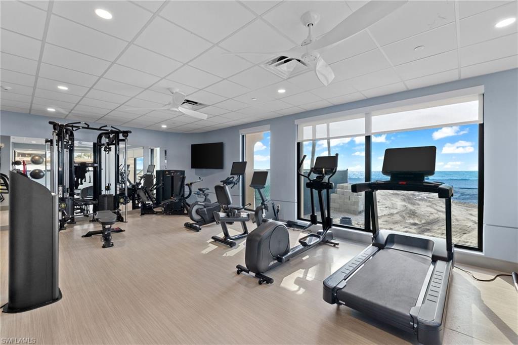 Workout area with a drop ceiling, visible vents, carpet, and recessed lighting