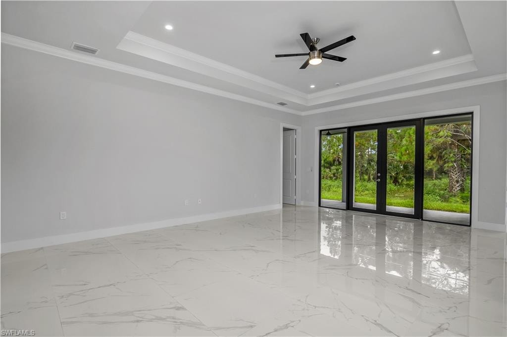 Empty room with ceiling fan, crown molding, french doors, light marble finish flooring, and recessed lighting