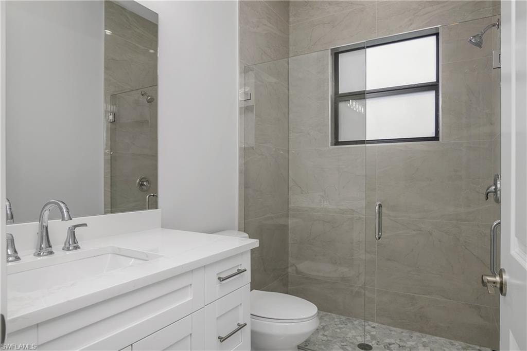 Bathroom featuring vanity and a stall shower