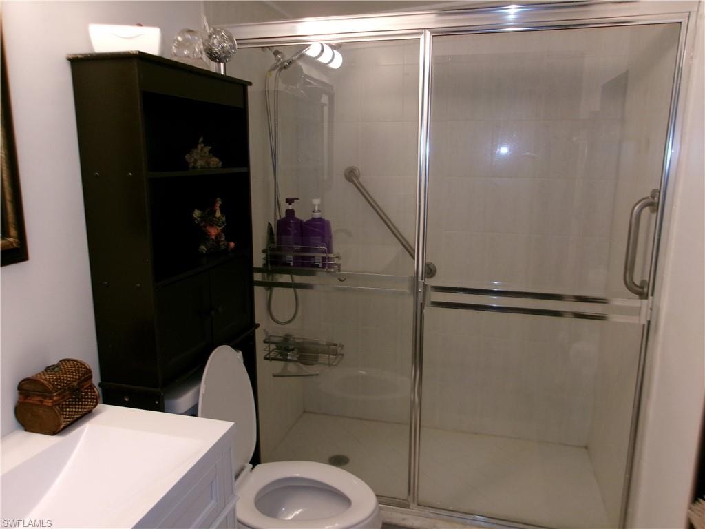 Bathroom featuring vanity and a stall shower