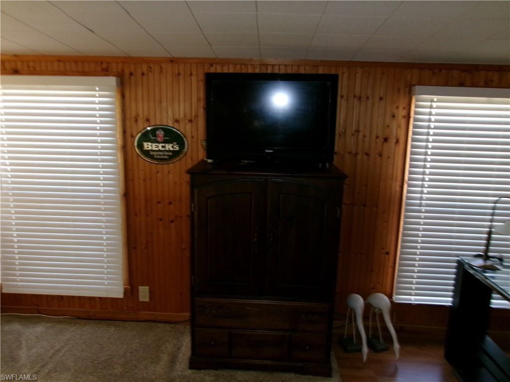 Living area featuring wood walls
